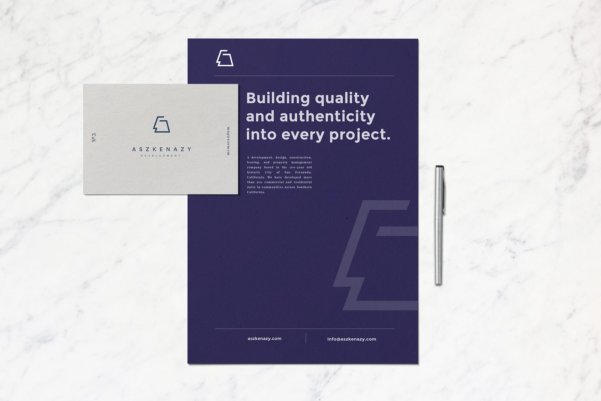 Aszkenazy Development memorandum and business card laid out on marble