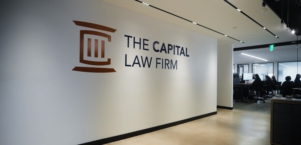 The Capital Law Firm — bronze logo applied to the office reception wall